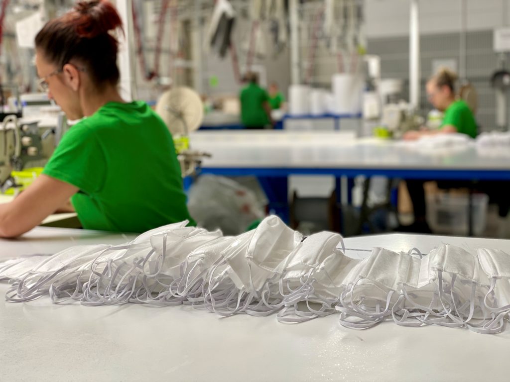 Co-workers in Poland sewing face masks